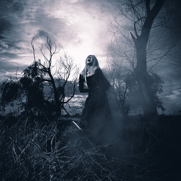 Una mujer gritando con aspecto de bruja en la niebla