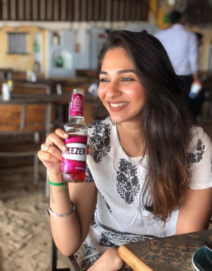 Vidhi Pandya con una botella de alcohol