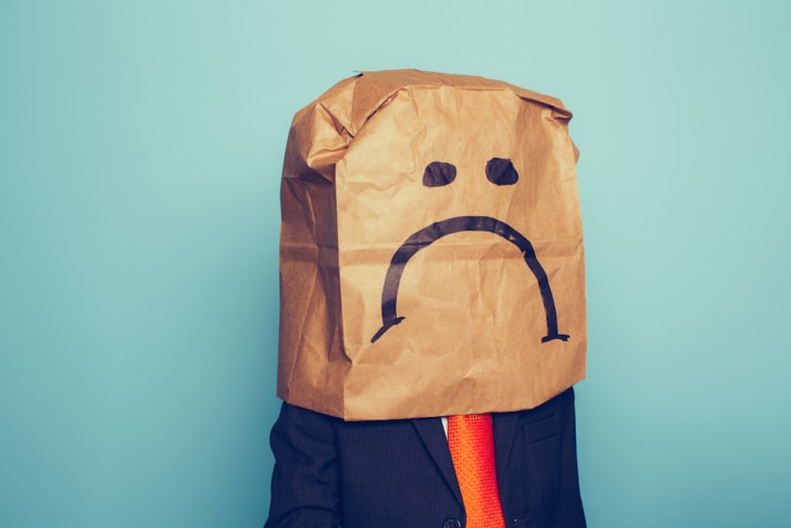 25 palabras inteligentes que deberías usar pero no las usas una persona que lleva una bolsa en la cabeza con el ceño fruncido